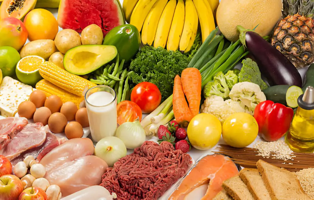 Bowl of gut-friendly foods like kimchi, greens, and lemon water for healing the gut and balancing hormones naturally.